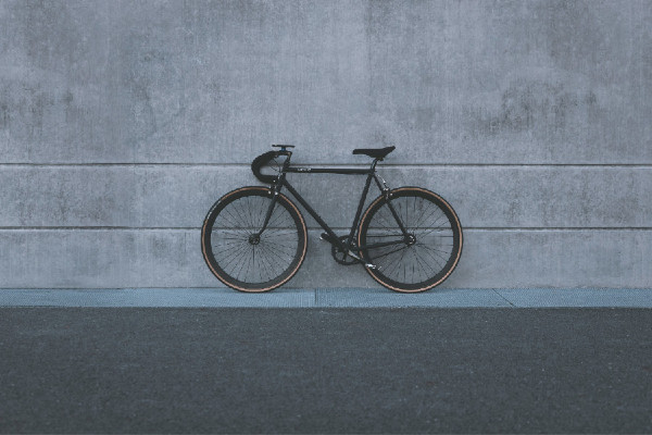 Bike standing on a sidewall against a concrete wall